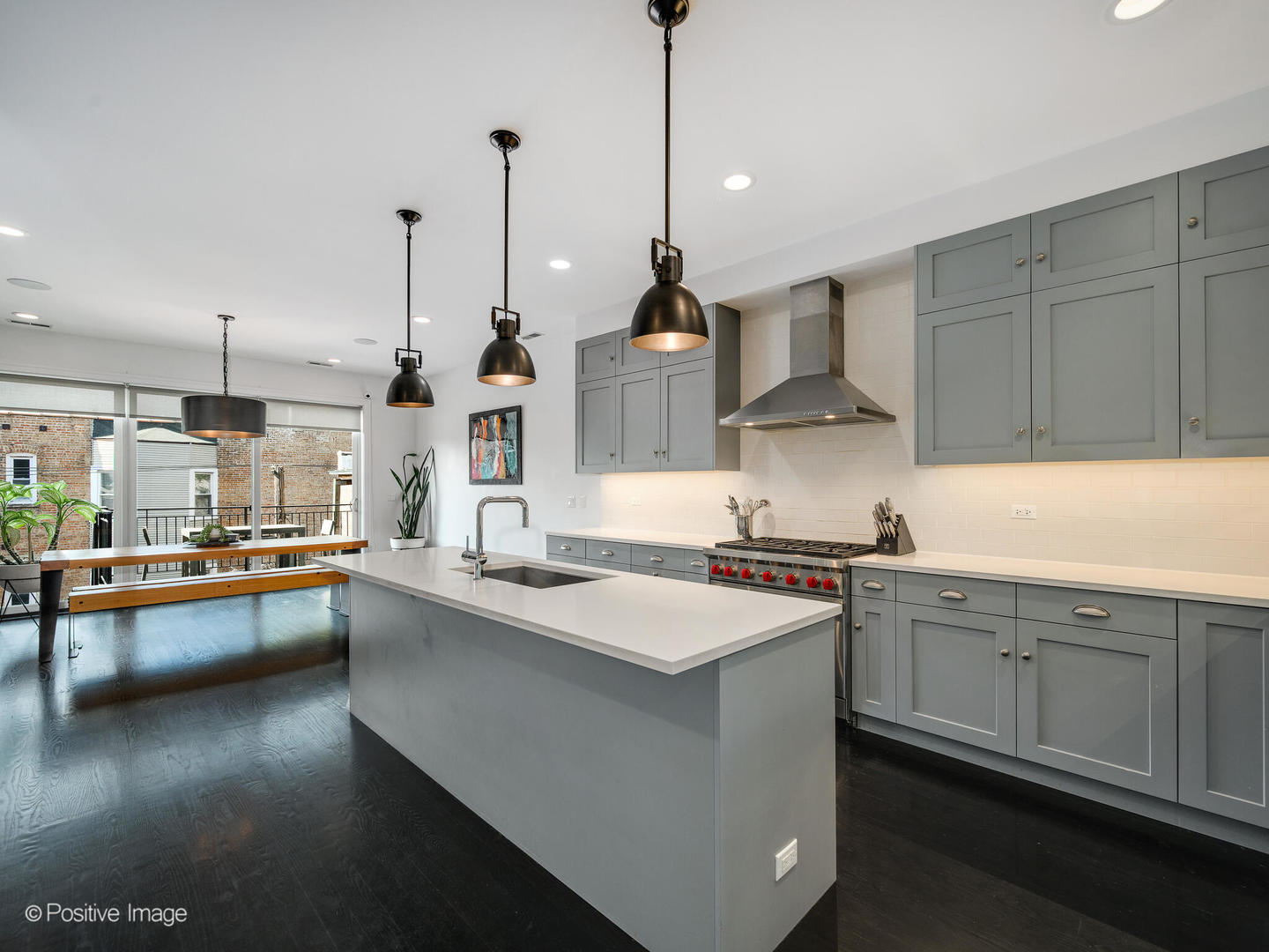 2922 North Sheffield Avenue, Unit 3 Chicago, IL 60657 - Photo 9 of 28 a kitchen with stainless steel appliances granite countertop a sink a stove and a wooden floors