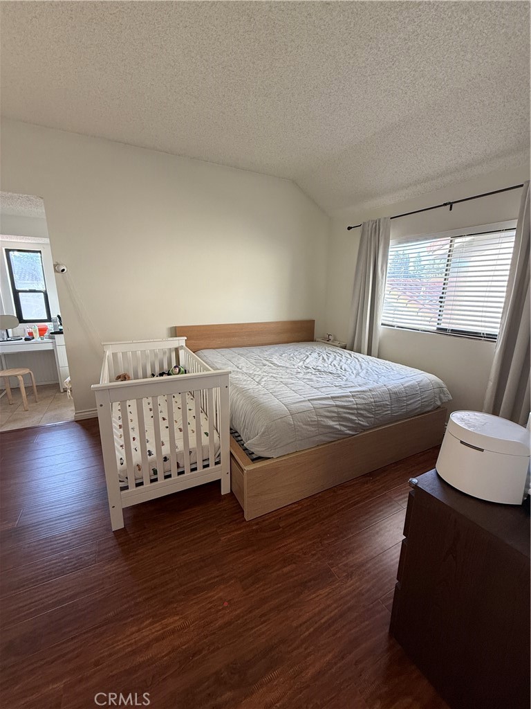 5 Fasano Irvine, CA 92620 - Photo 3 of 10 a bedroom with a bed and wooden floor