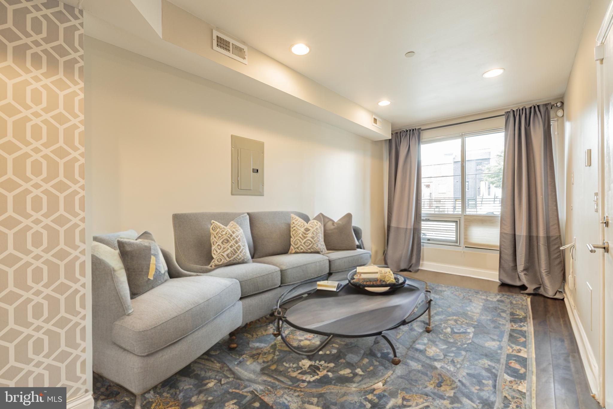 1815 Benning Road Northeast, Unit 2 Washington, DC 20002 - Photo 2 of 12 a living room with furniture and a large window