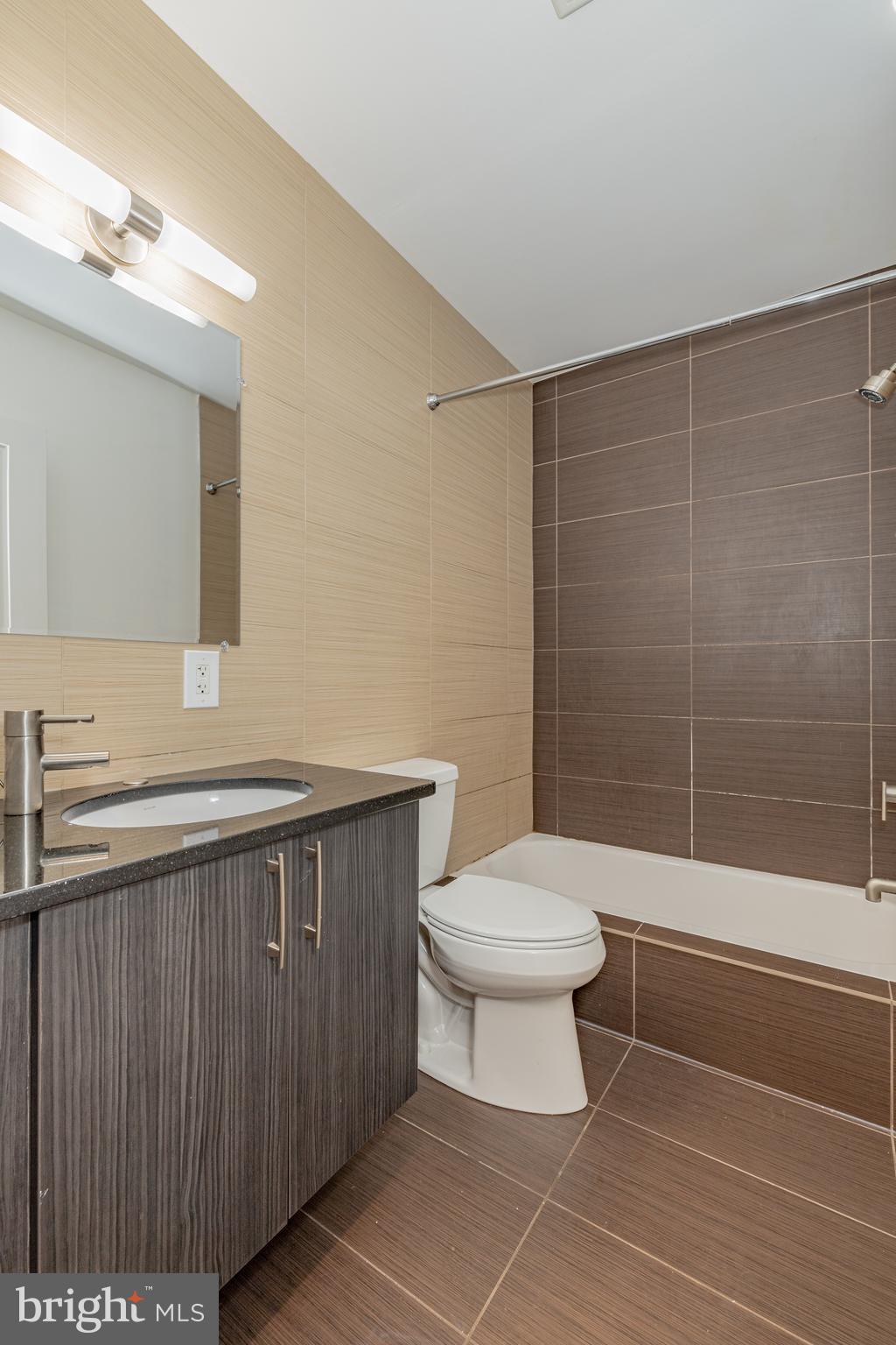 1815 Benning Road Northeast, Unit 2 Washington, DC 20002 - Photo 5 of 12 a bathroom with a sink a toilet and shower