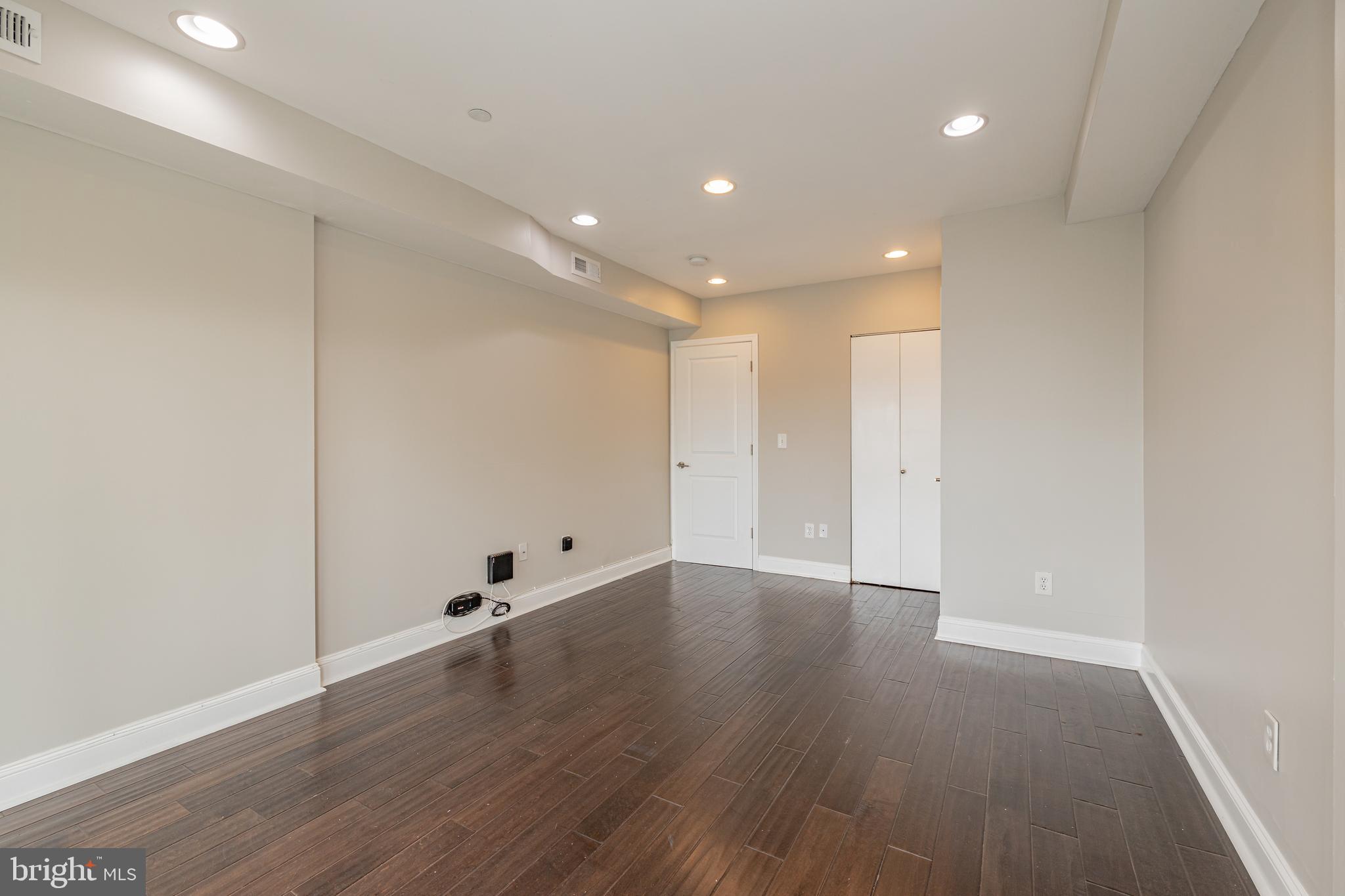 1815 Benning Road Northeast, Unit 2 Washington, DC 20002 - Photo 7 of 12 a view of an empty room with wooden floor