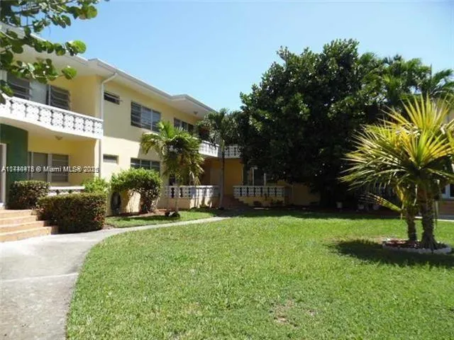 a view of a house with a yard and a patio