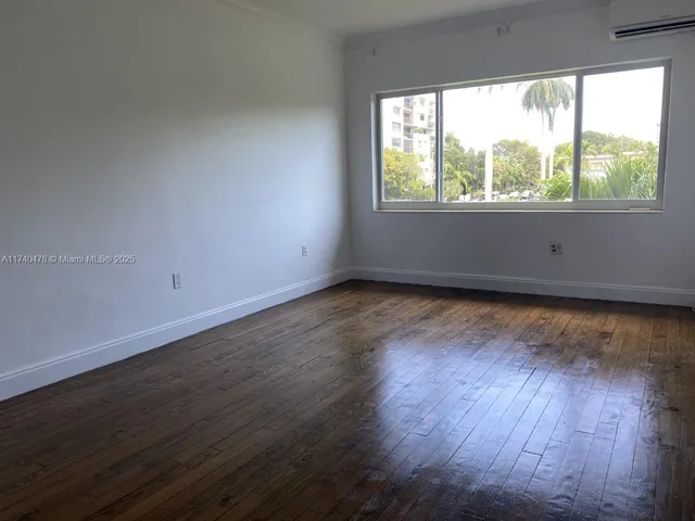 an empty room with wooden floor