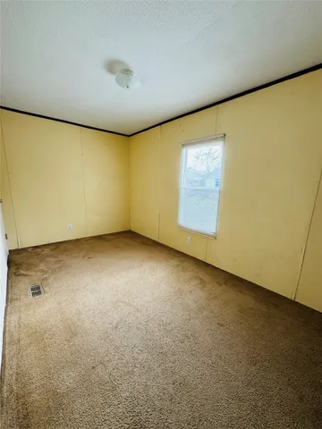 an empty room with a empty space and a window