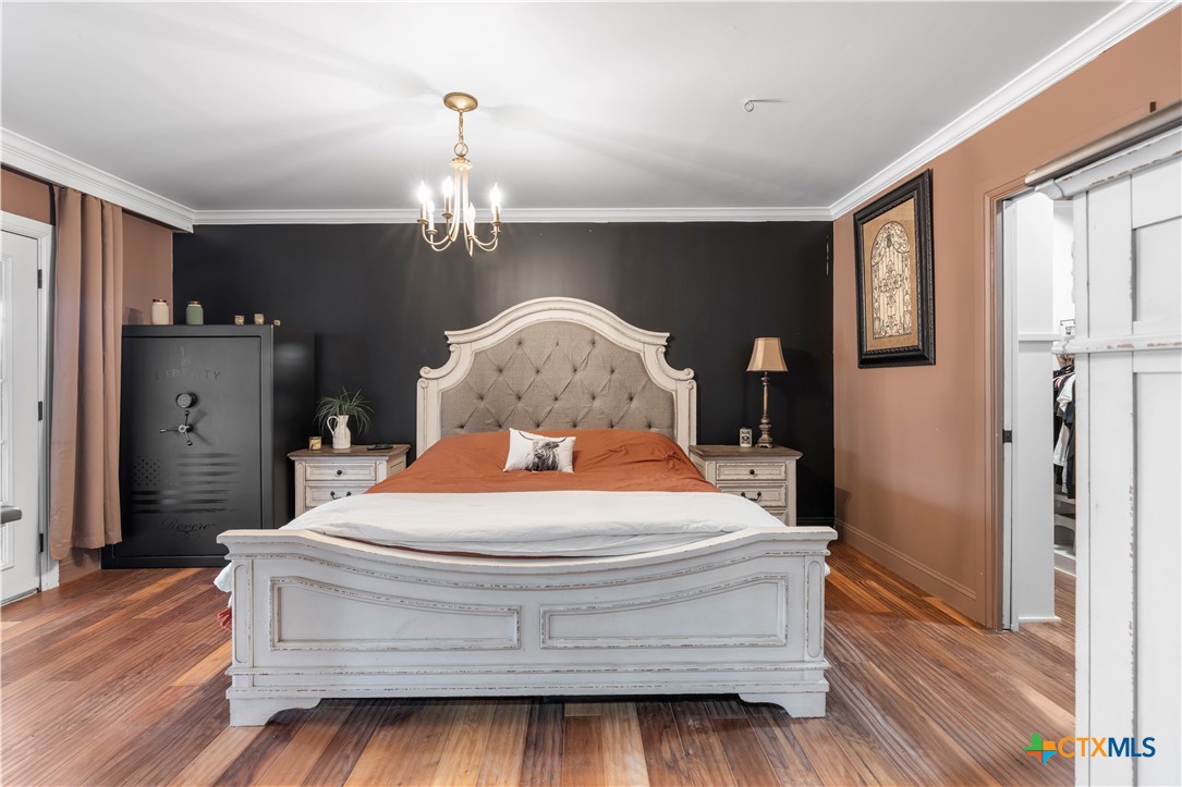 308 Liberty Street Gatesville, TX 76528 - Photo 12 of 41 a room with a bed chandelier and a window