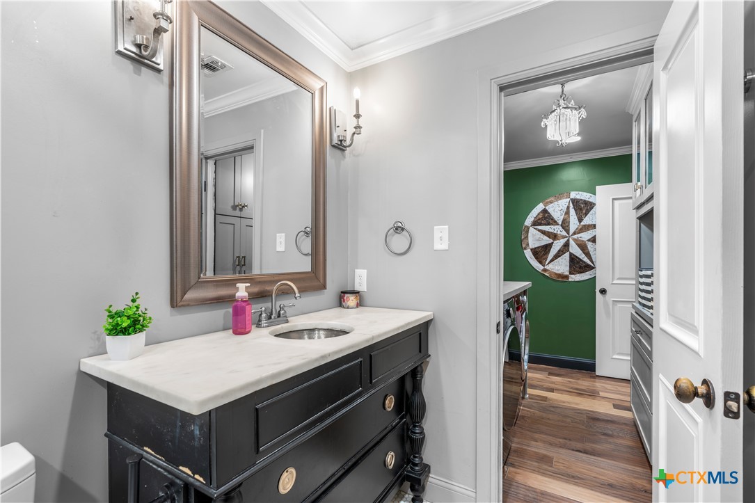 308 Liberty Street Gatesville, TX 76528 - Photo 16 of 41 a bathroom with a sink and a mirror