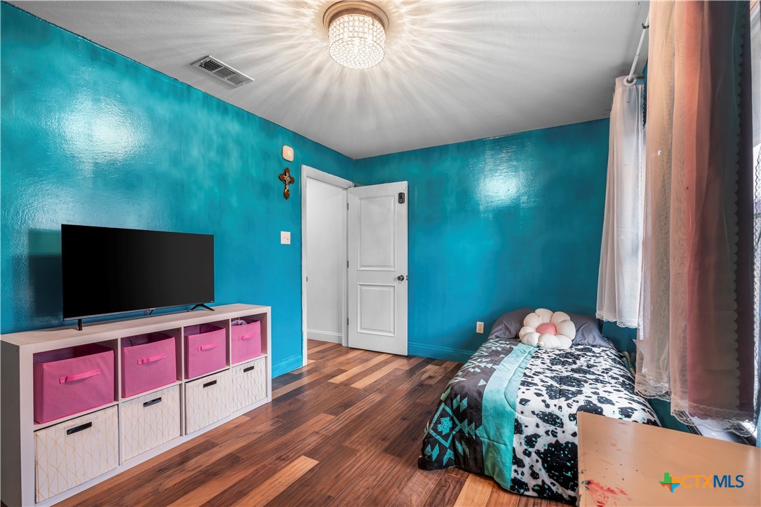 308 Liberty Street Gatesville, TX 76528 - Photo 20 of 41 a bedroom with a bed and a flat screen tv