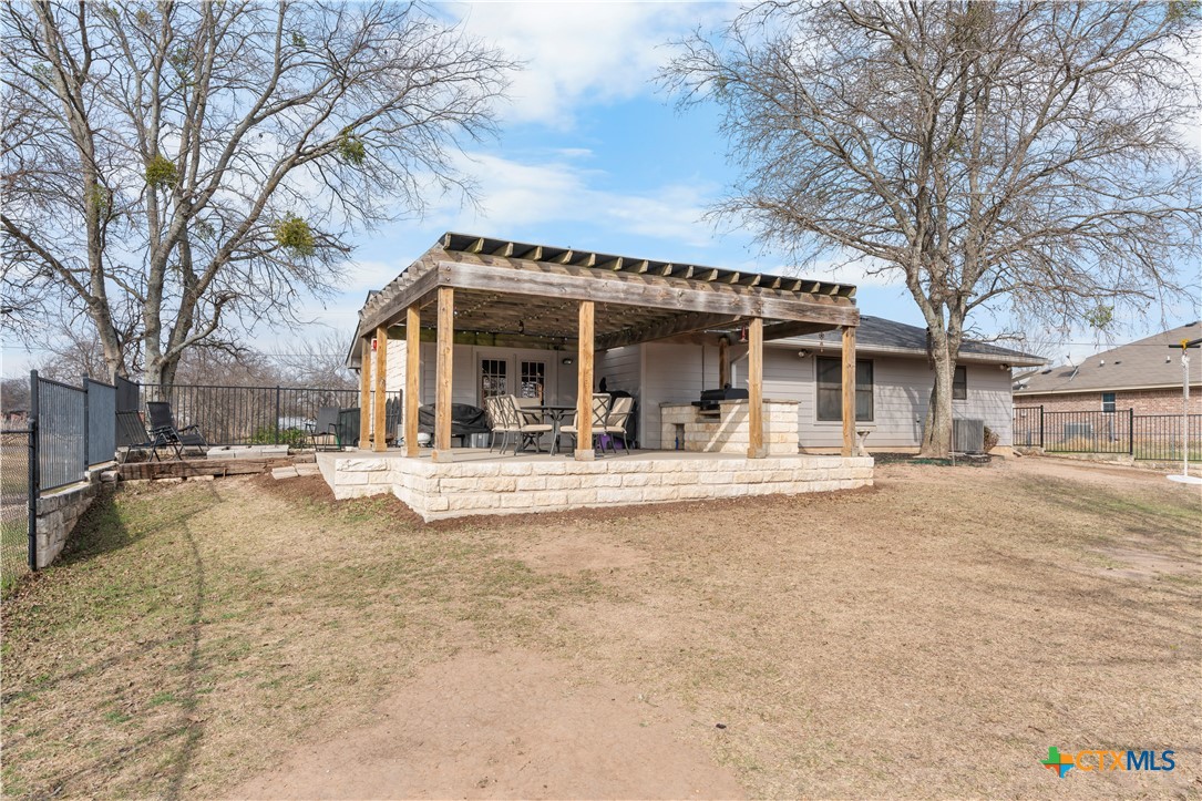 308 Liberty Street Gatesville, TX 76528 - Photo 30 of 41 a view of a white house with a large tree and plants