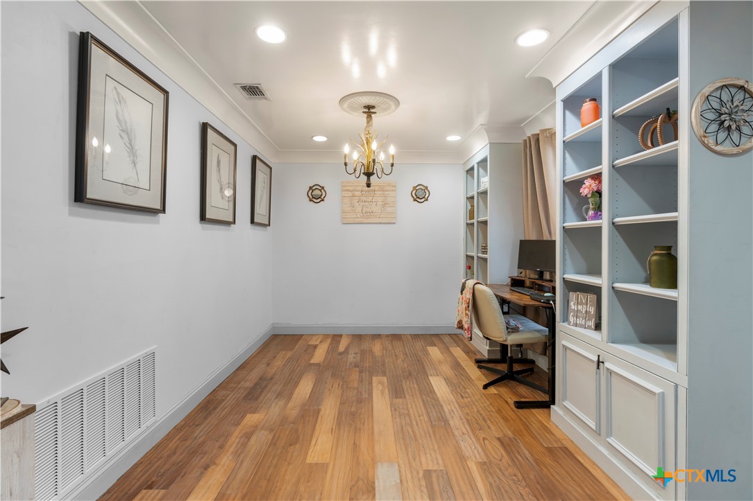 308 Liberty Street Gatesville, TX 76528 - Photo 5 of 41 a view of entryway with workspace and wooden floor