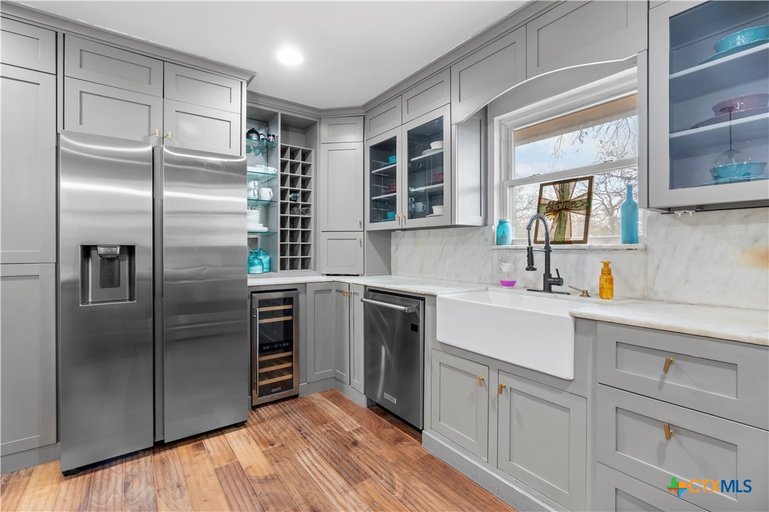 308 Liberty Street Gatesville, TX 76528 - Photo 6 of 41 a kitchen with a refrigerator sink and cabinets