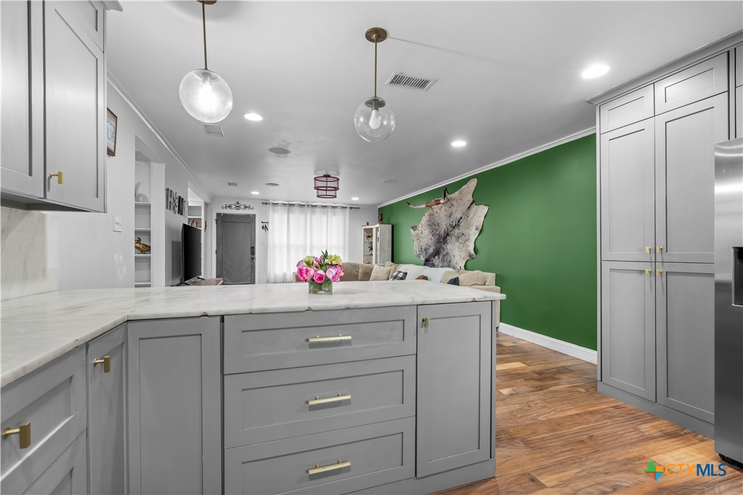 308 Liberty Street Gatesville, TX 76528 - Photo 7 of 41 a kitchen with kitchen island a sink stainless steel appliances and cabinets