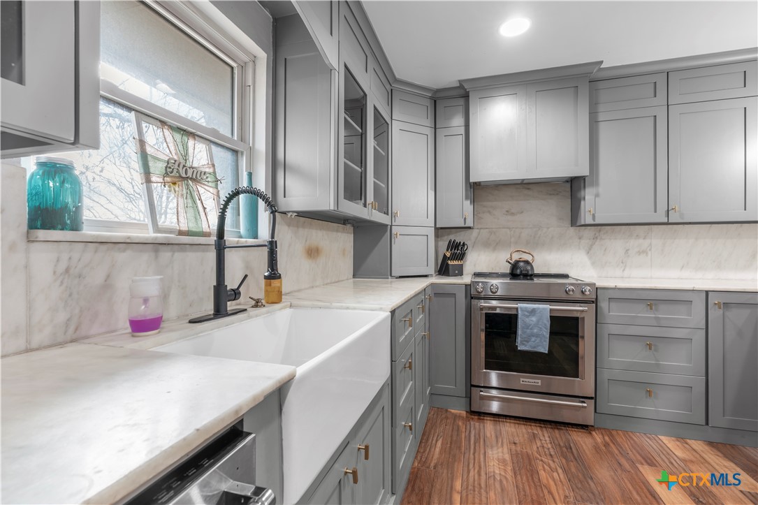 308 Liberty Street Gatesville, TX 76528 - Photo 8 of 41 a kitchen with a sink cabinets and appliances
