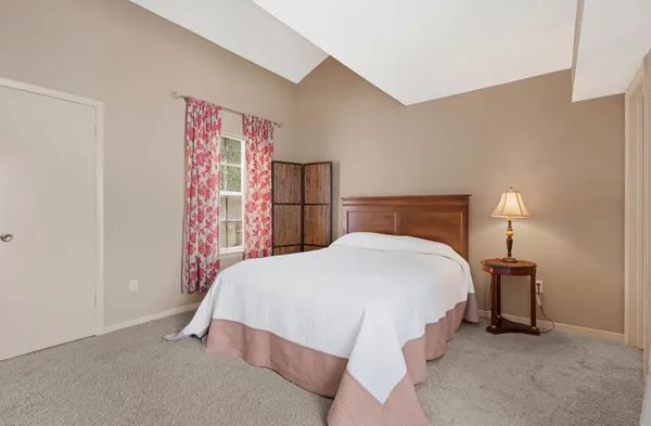 a bedroom with a bed and a lamp