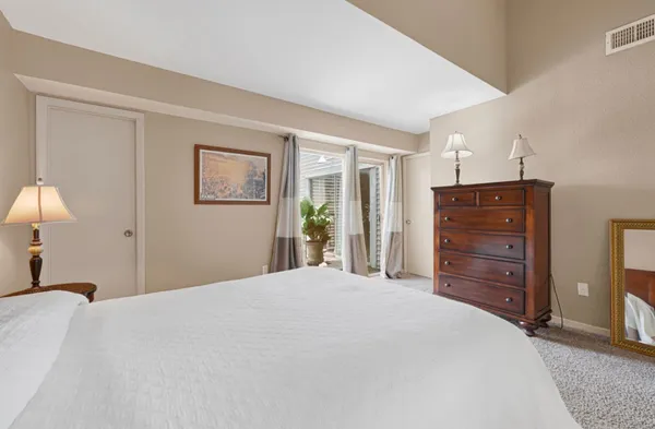 a bedroom with a bed and a dresser