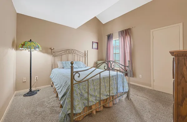 a view of a bedroom with furniture