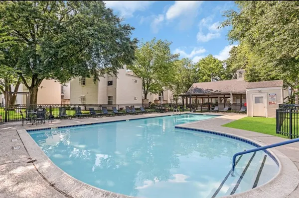 a view of a swimming pool with a lounge chair
