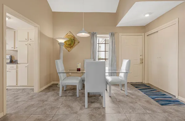 a dining room with furniture and window