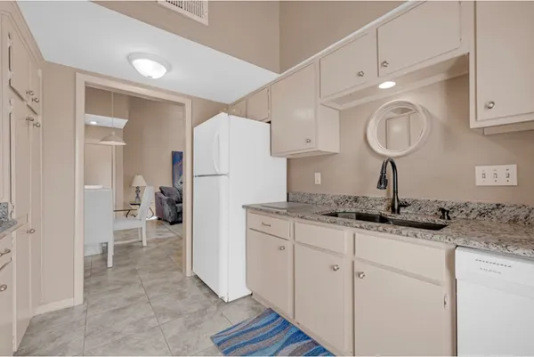 a kitchen with a sink cabinets and a refrigerator