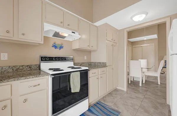 a kitchen with granite countertop a sink and a stove top oven