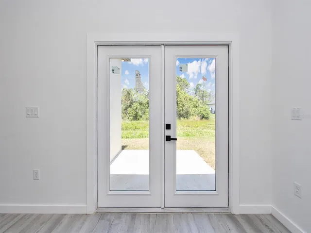 an empty room with a window and a ceiling fan