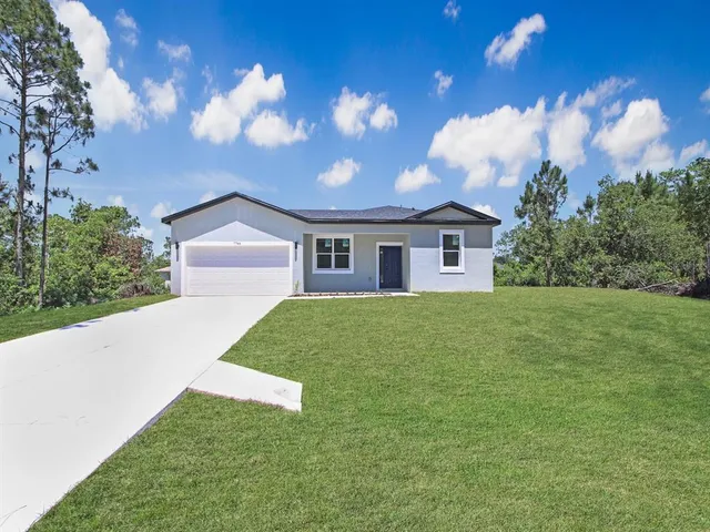 a view of house with yard