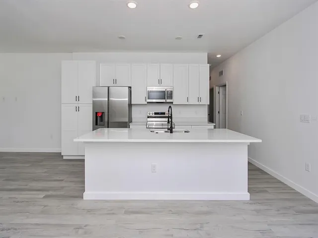 a kitchen that has a sink and a stove