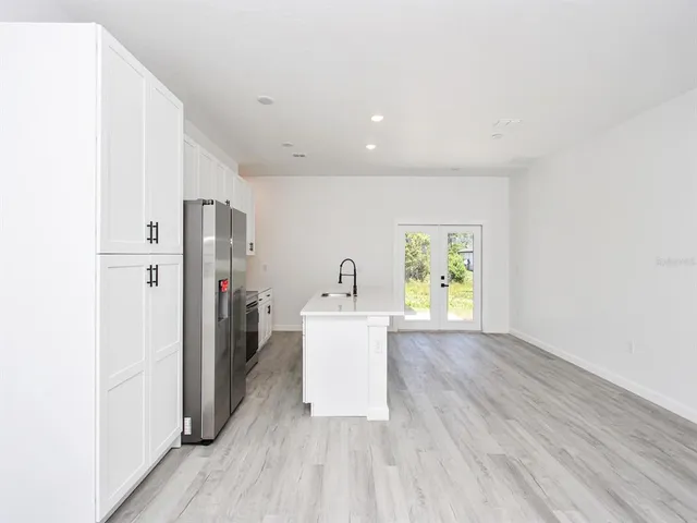 an empty room with a sink and a mirror