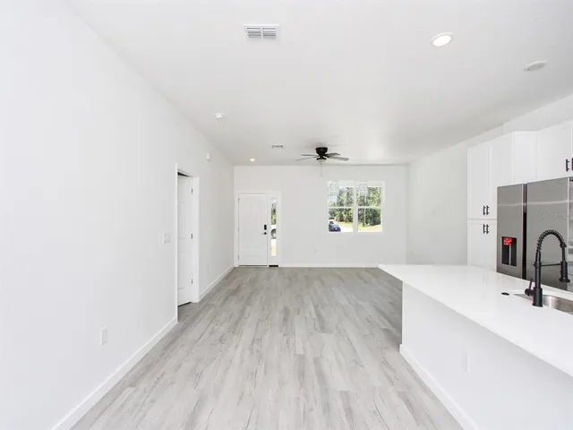 a kitchen with stainless steel appliances a refrigerator sink and microwave