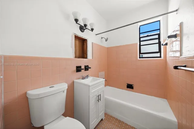 a bathroom with a toilet a sink and bathtub