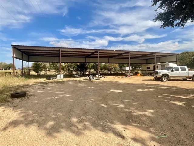a view of building with car parked