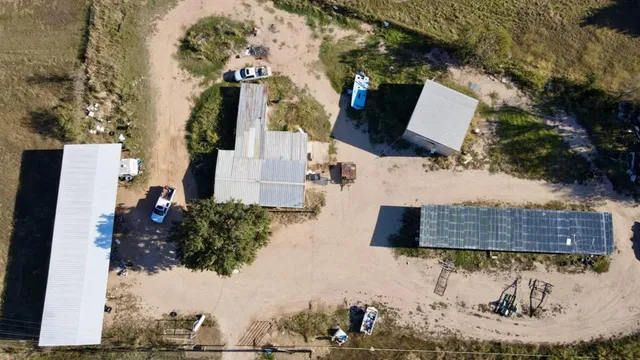 an aerial view of house with a yard