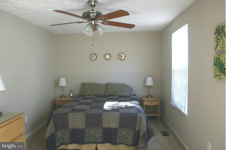 6906 Villa-Del-Rey Court Springfield, VA 22150 - Photo 13 of 23 a bed sitting in a bedroom next to a window