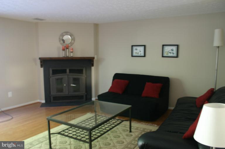 6906 Villa-Del-Rey Court Springfield, VA 22150 - Photo 14 of 23 a living room with furniture and a fireplace