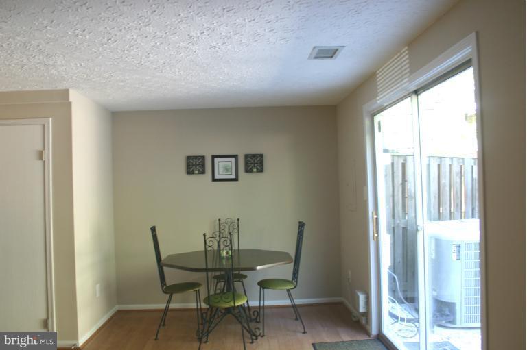 6906 Villa-Del-Rey Court Springfield, VA 22150 - Photo 22 of 23 a view of a dining room with furniture and a window