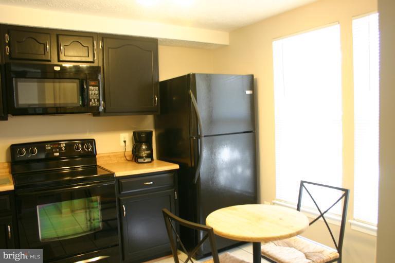 6906 Villa-Del-Rey Court Springfield, VA 22150 - Photo 4 of 23 a kitchen with stainless steel appliances granite countertop a refrigerator a stove a sink and a refrigerator