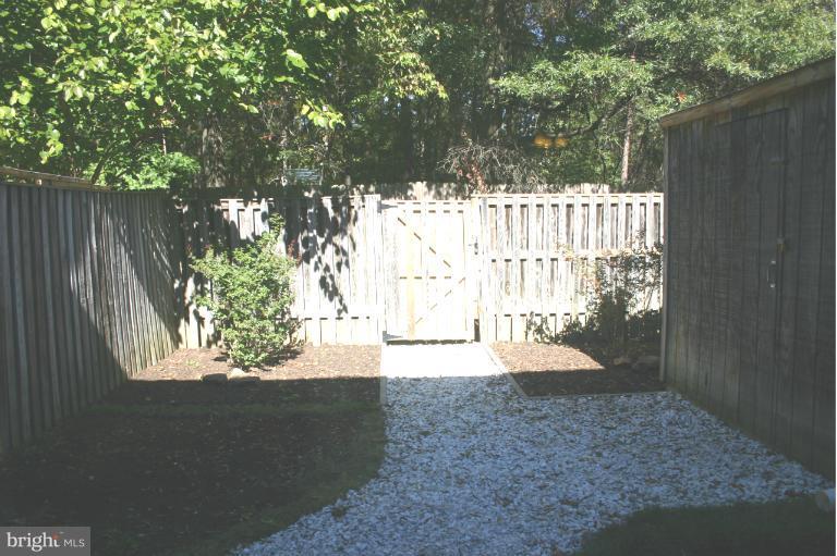 6906 Villa-Del-Rey Court Springfield, VA 22150 - Photo 9 of 23 a view of a yard with wooden fence