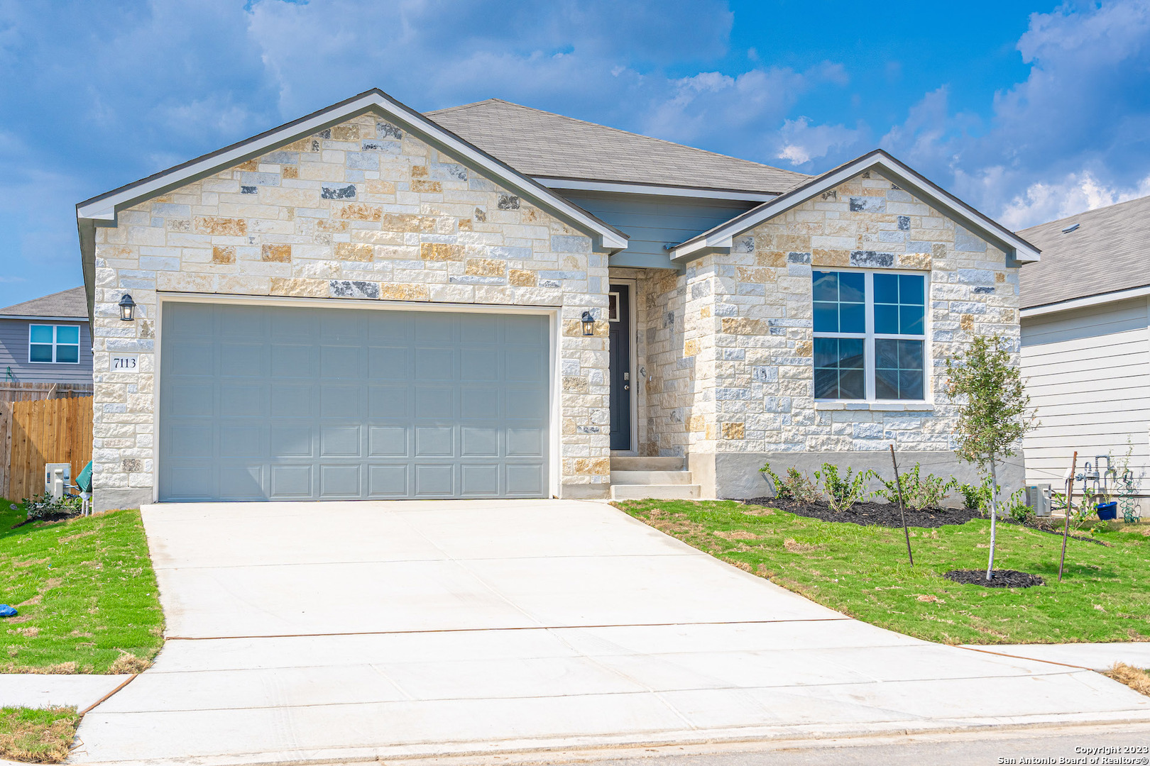a front view of a house with garden