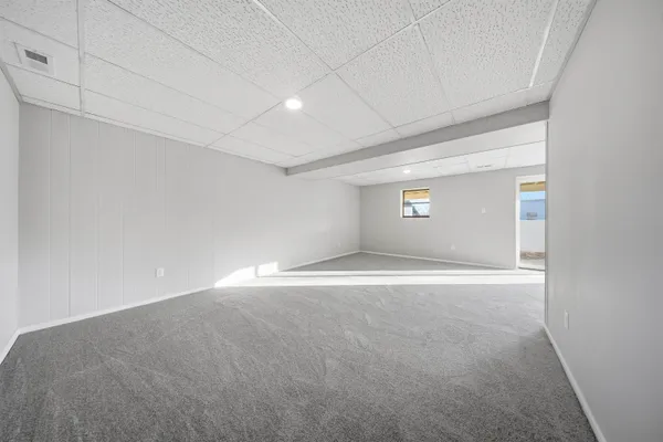 a view of a houses with yard and wooden fence