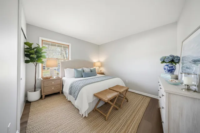 a bedroom with a bed and a potted plant