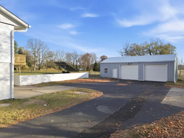 a view of a hallway with wooden floor and windows