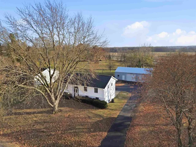 a view of a houses with yard and wooden fence