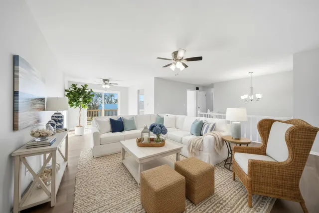 a living room with furniture or chandelier and a wooden floor