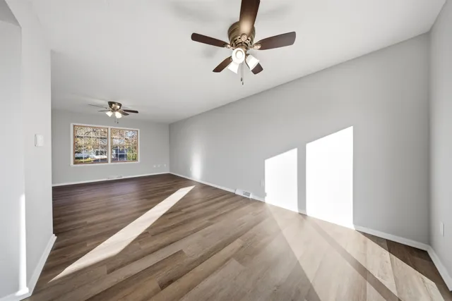 wooden floor in an empty room with a window