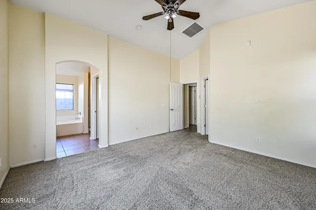 an empty room with a empty space and a ceiling fan
