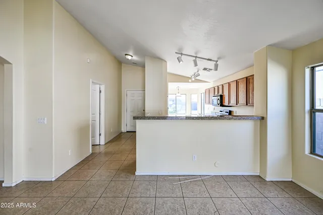 a view of a kitchen with a refrigerator and window