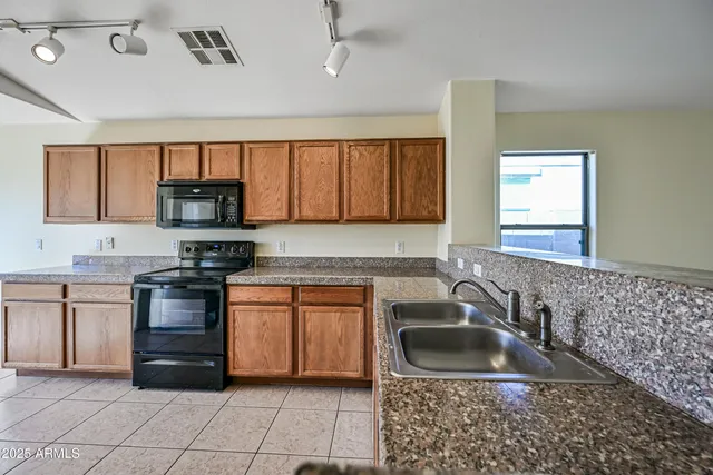 a kitchen with a sink stove and microwave