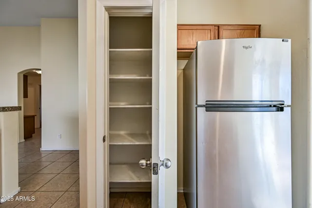 a white refrigerator freezer and a granite counter top