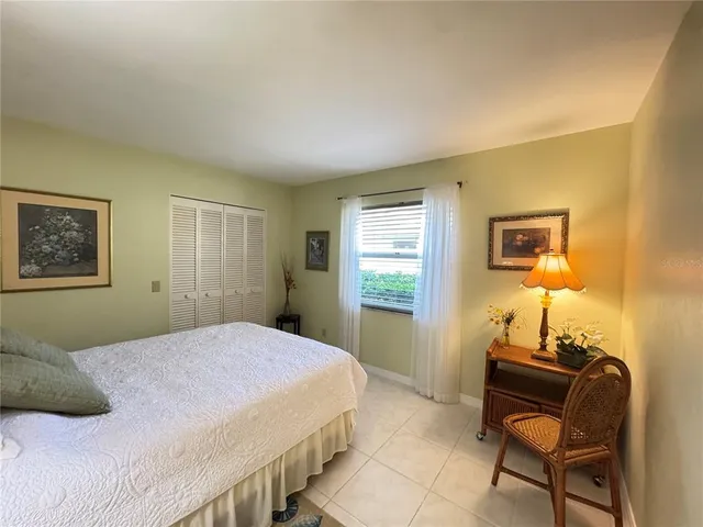 a bedroom with a bed and a table