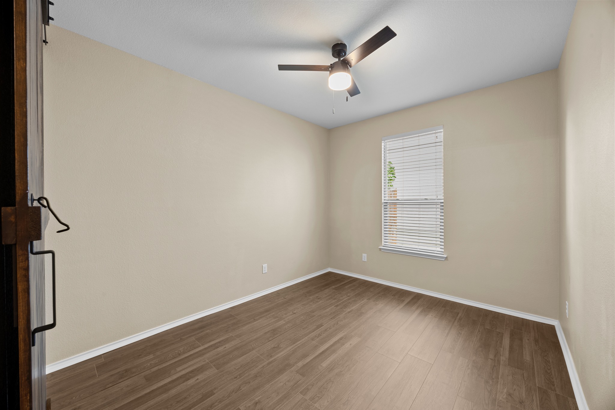 1125 Yellow Iris Road Leander, TX 78641 - Photo 11 of 31 Unfurnished room with dark wood-style flooring and ceiling fan