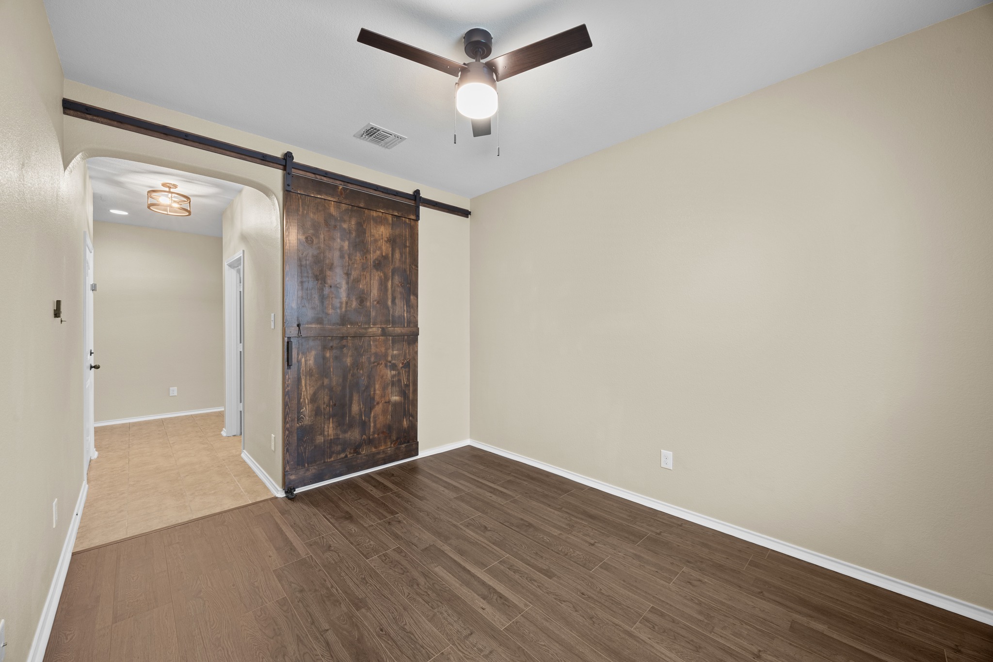1125 Yellow Iris Road Leander, TX 78641 - Photo 12 of 31 Unfurnished room with dark wood-style flooring and ceiling fan